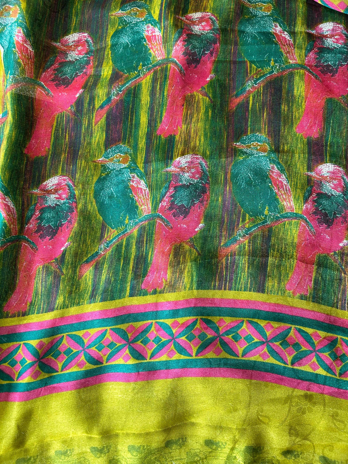 Colorful fabric with bird pattern and geometric border