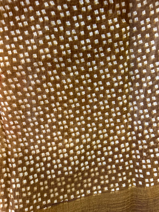 Close-up of a textured brown fabric with a subtle pattern